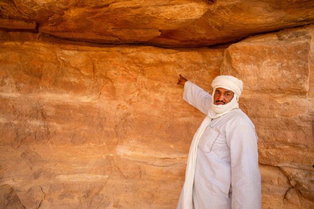 Mohamad ukazuje neolytické maľby na stenách Tassili n'Ajjer. Vi