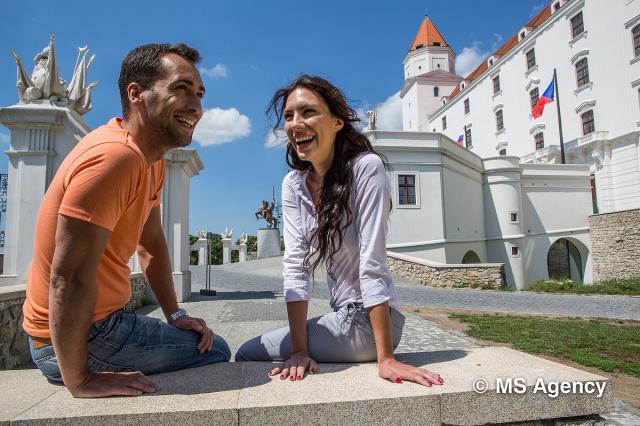 A couple sitting in front of the Bratislava Castle-min.jpg
